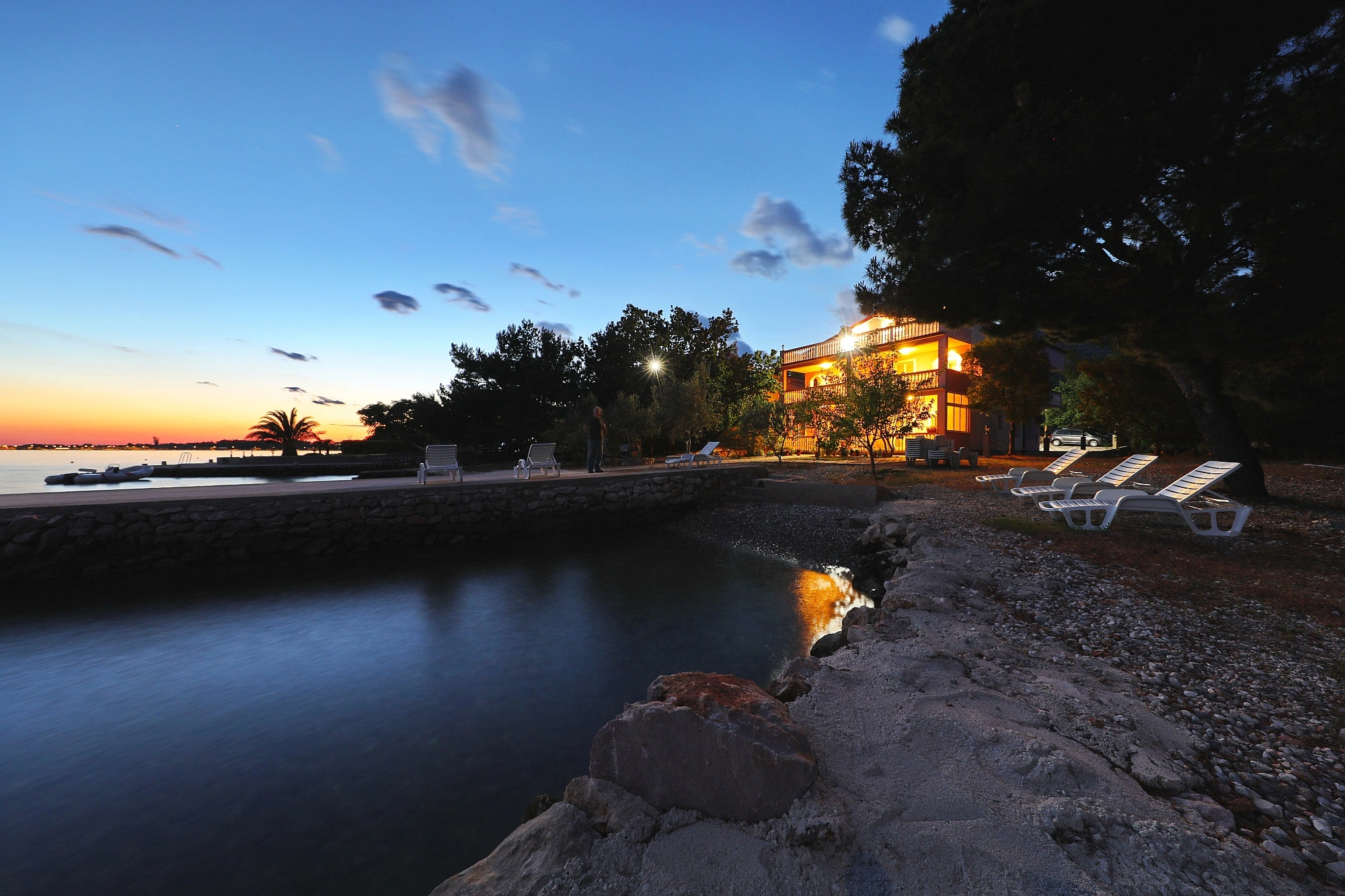 Exterior view of Villa Rajna beachfront apartments in Starigrad-Paklenica with the Adriatic Sea in the foreground.